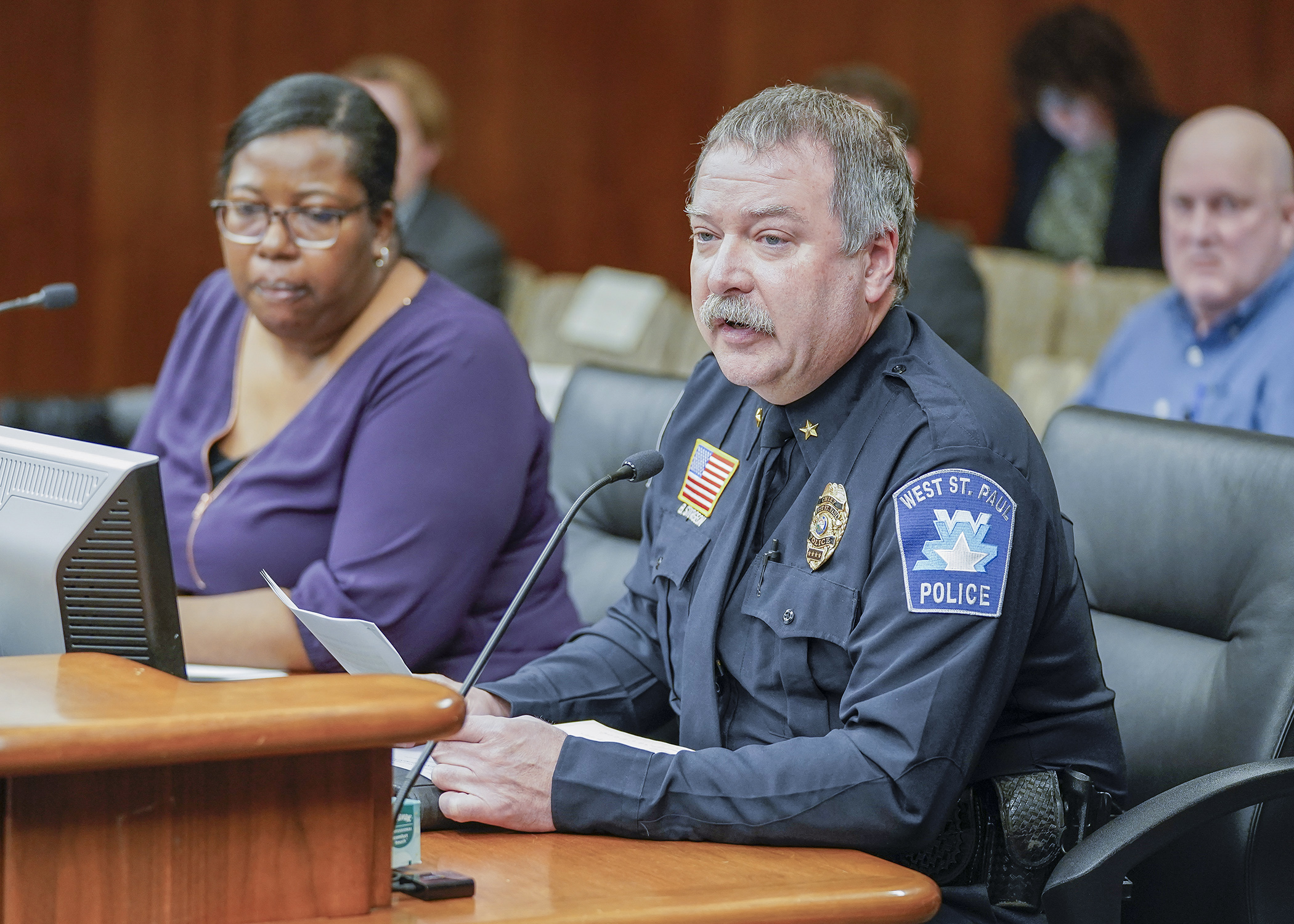 West St. Paul Police Chief Brian Sturgeon testifies before House lawmakers Jan. 23 in support of a bill sponsored by Rep. Ruth Richardson, left, that would establish catalytic converter purchase requirements. (Photo by Andrew VonBank)